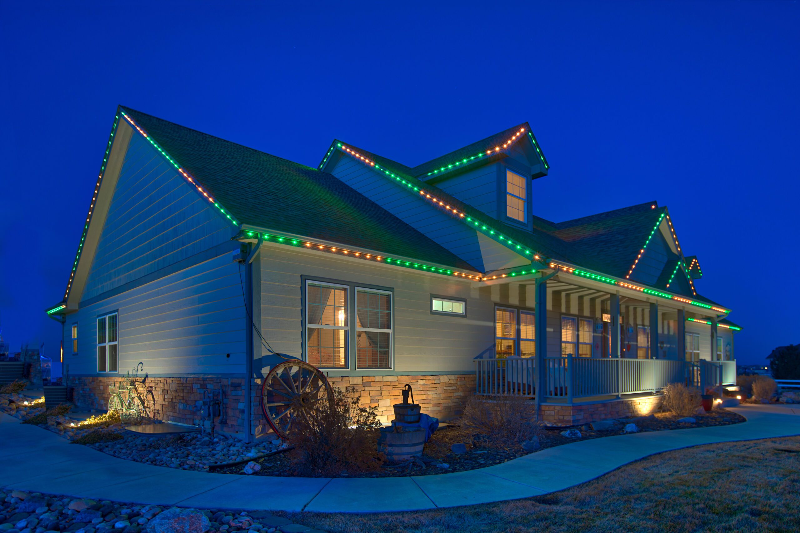 Ranch home with permanent holiday lighting in Green and Warm white colors