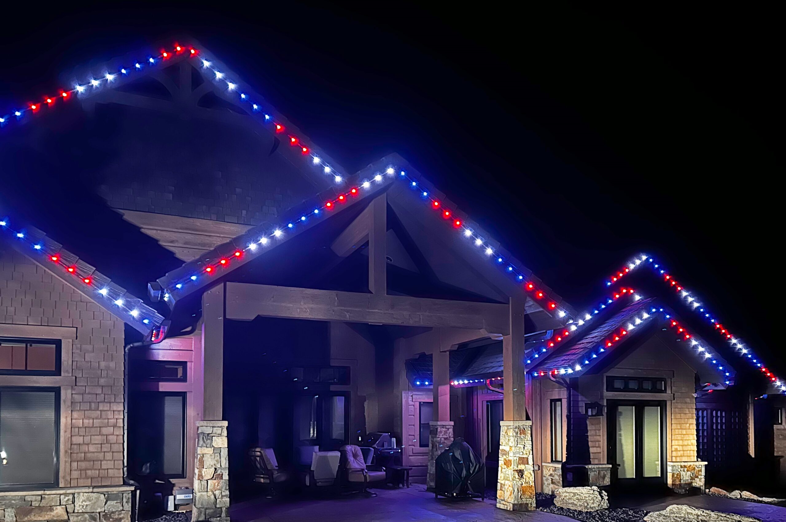 Back patio with colorful permanent holiday lights in Red White and Blue for 4th of July