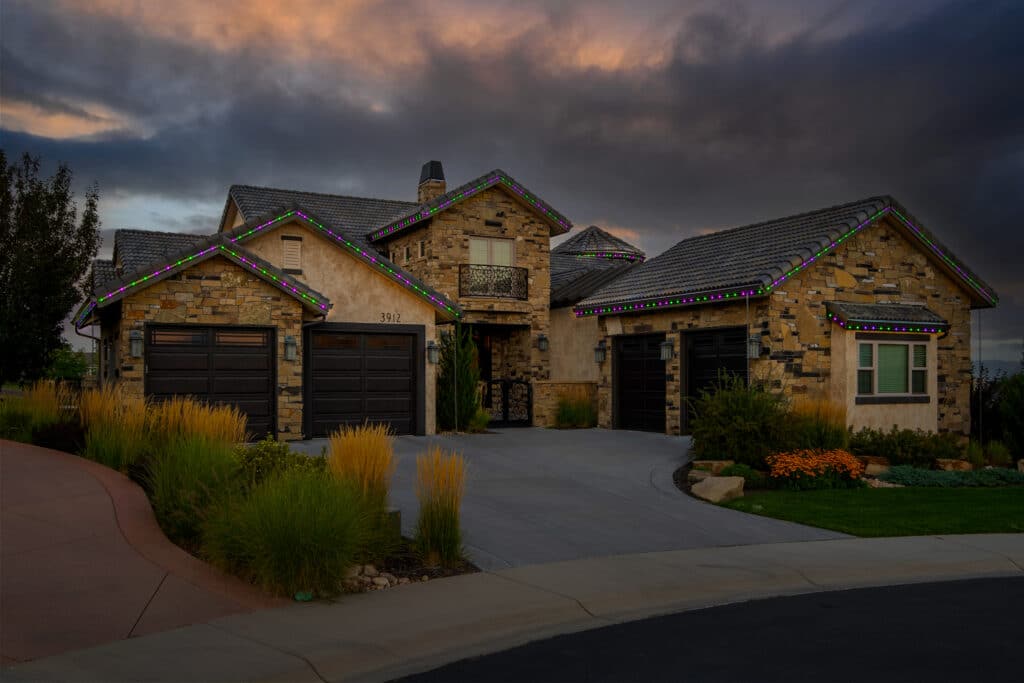 House decorated in permanent outdoor LEDs in purple and green