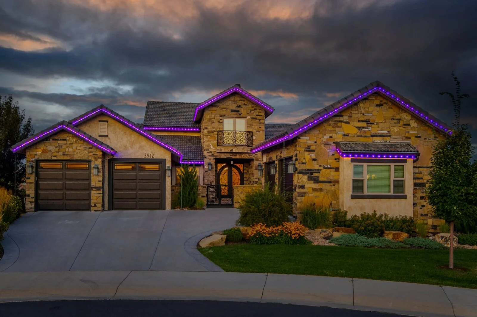 Front of house decorated in permanent outdoor LEDs in purple