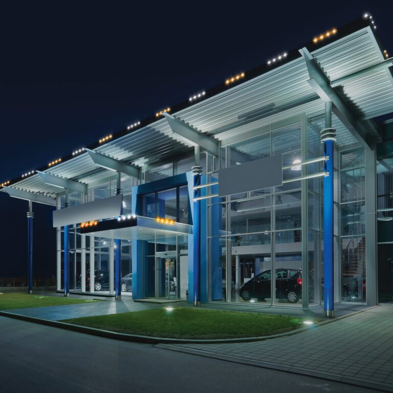 Auto dealership with orange and white commercial accent lighting