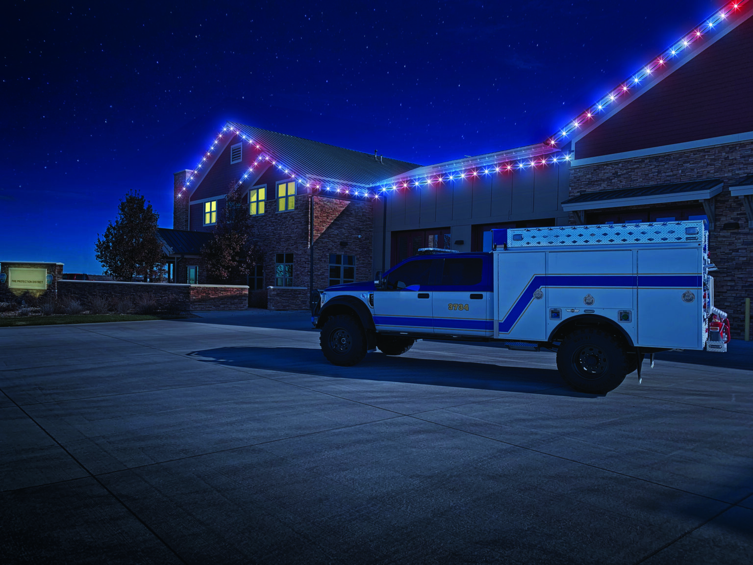 First Responder truck in front of fire station decorated in red white and blue lighting