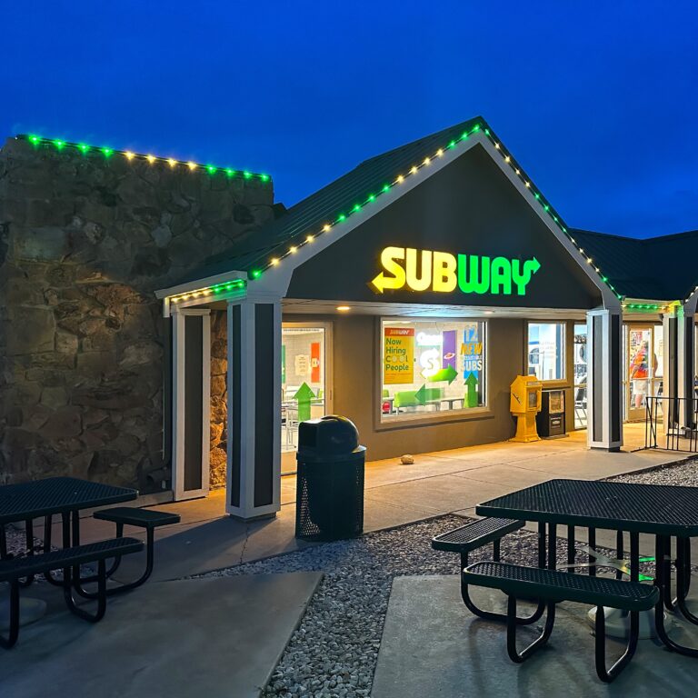 Subway sandwich store front with yellow and green decorative lighting