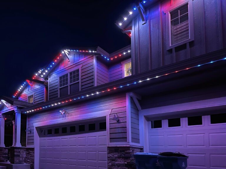 Close up of homes roofline with Red, White, and Blue permanent decorative lighting