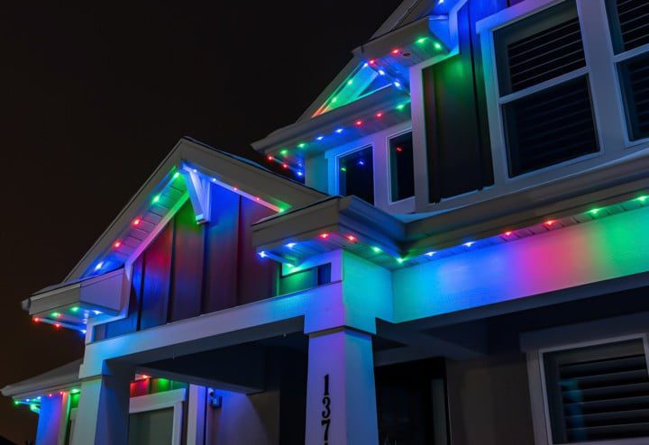 Close up view of house decorated in Red, Blue, and Green trim lighting