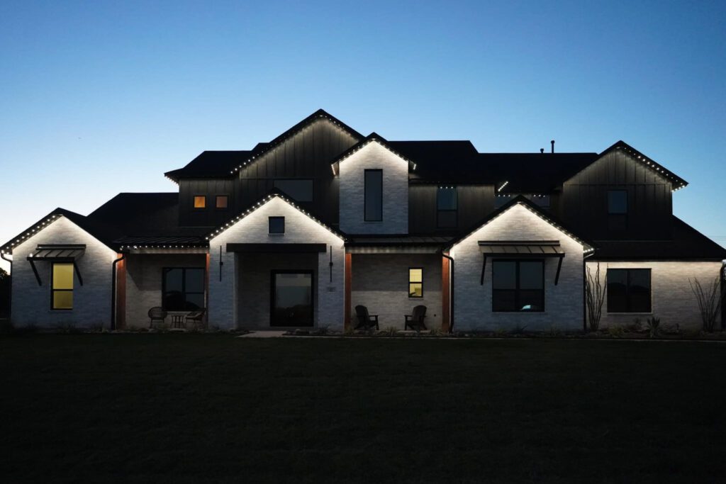 Elegant house with permanent roofline lighting installed for year-round elegance.