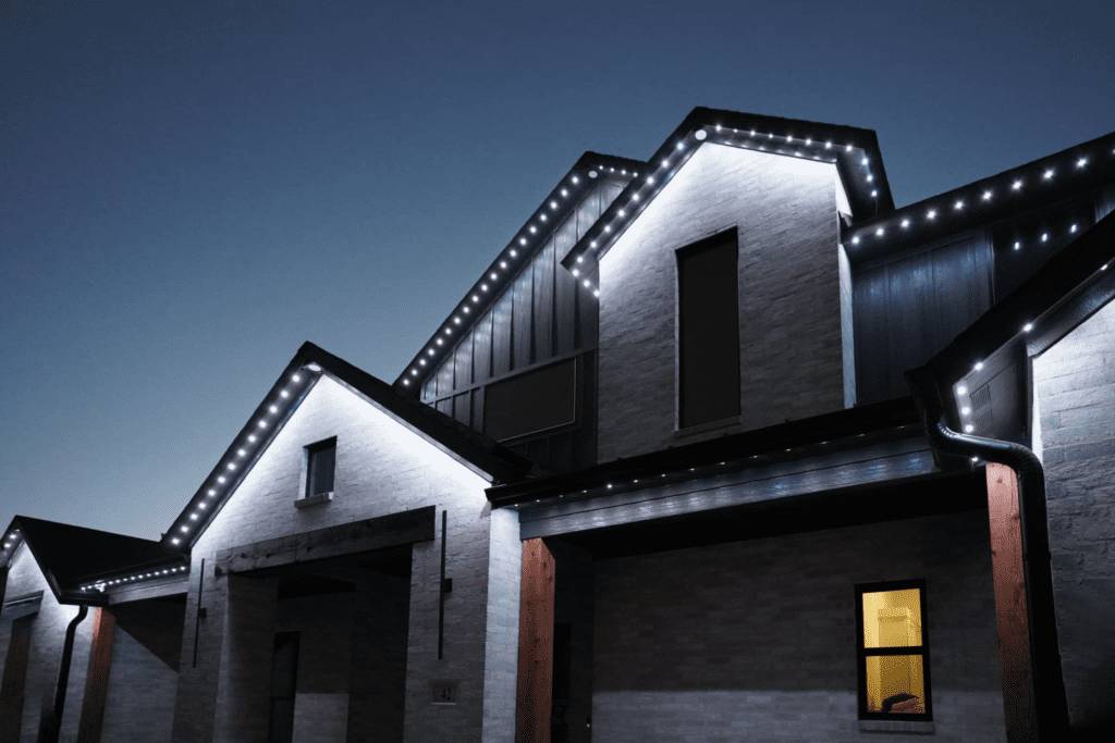 Permanent outdoor lighting in a sleek, modern white design on a contemporary home.