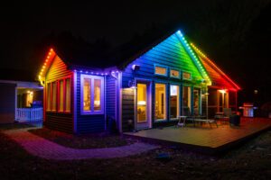 Permanent holiday lights illuminating a cozy home with a vibrant rainbow effect.