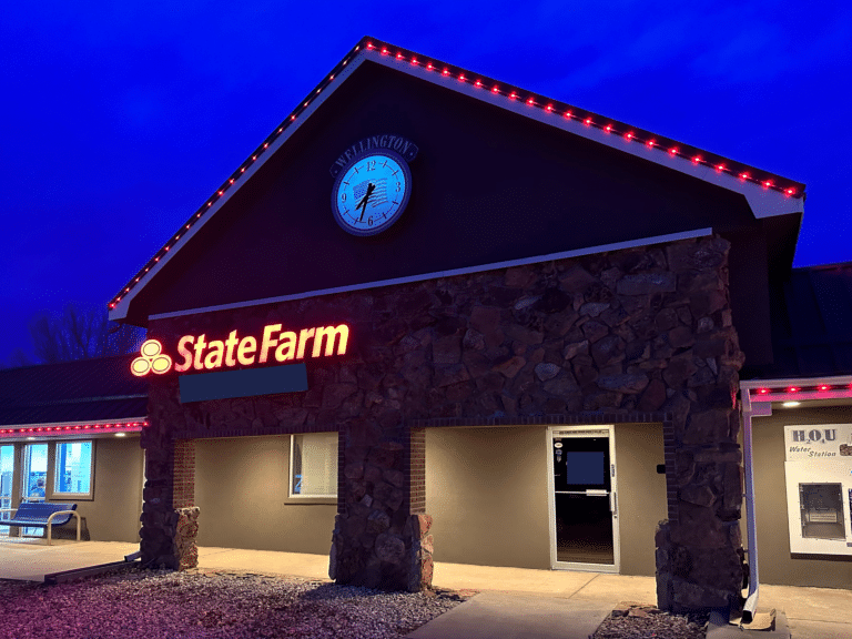 Commercial office building with red permanent LED trim lighting outlining roofline and facade at night